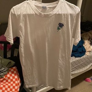 A white shirt size small with a blue rose on the corner